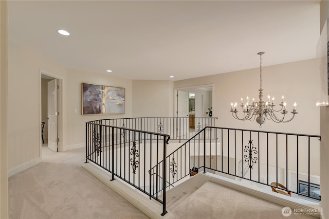 8228 NE 187th Way, Kenmore, WA 98028 - hall with an upstairs landing, a chandelier, carpet floors, and recessed lighting