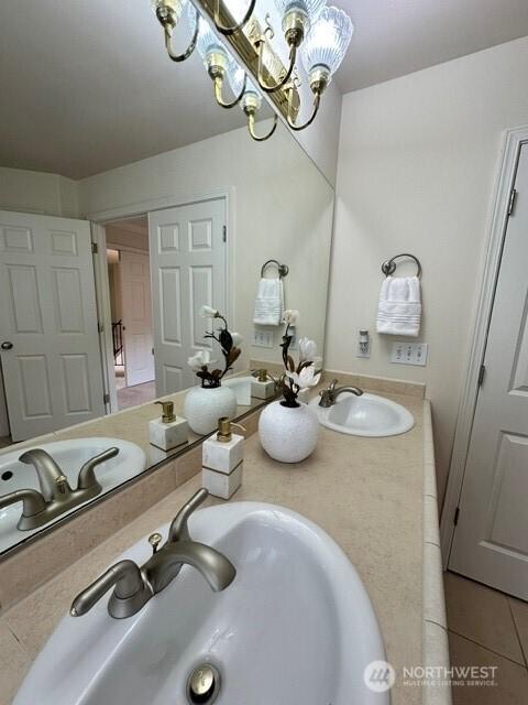 8228 NE 187th Way, Kenmore, WA 98028 - bathroom featuring tile patterned floors, double vanity, and a chandelier