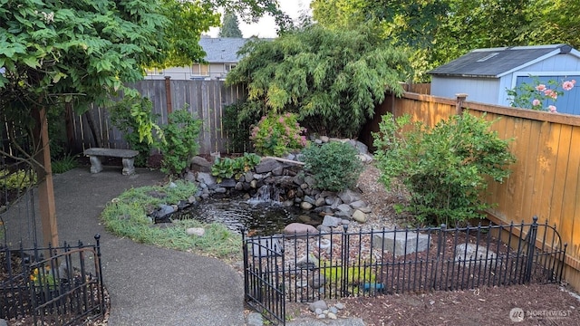 8318 55th Ave SE, Olympia, WA 98513 - fenced backyard with a storage unit and a small pond