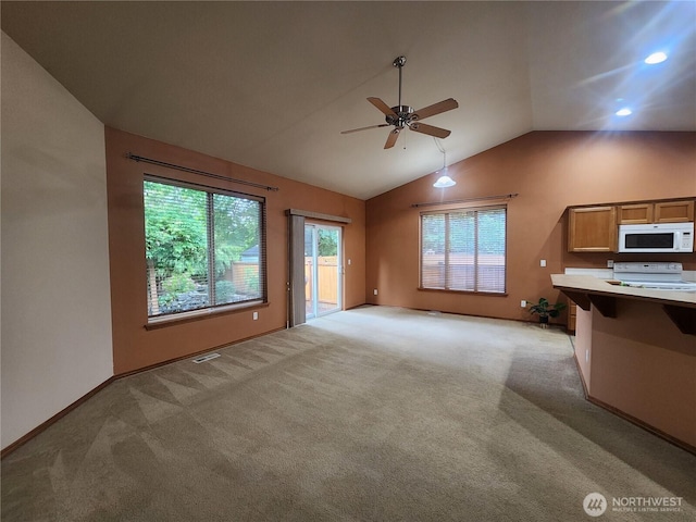 8318 55th Ave SE, Olympia, WA 98513 - unfurnished living room with a ceiling fan, lofted ceiling, light colored carpet, and recessed lighting