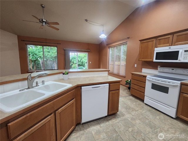 8318 55th Ave SE, Olympia, WA 98513 - kitchen with white appliances, vaulted ceiling, brown cabinets, light countertops, and ceiling fan