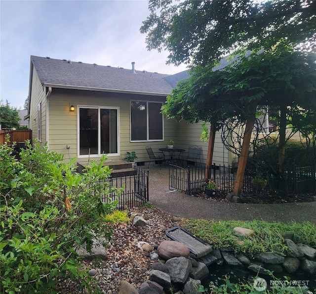 8318 55th Ave SE, Olympia, WA 98513 - back of house featuring a patio and a shingled roof