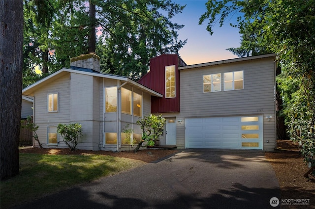 2127 170th Ave NE, Bellevue, WA 98008 - view of front facade with driveway, an attached garage, and a chimney