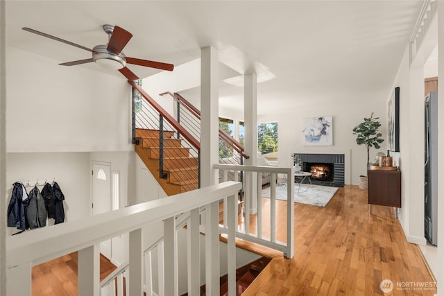 2127 170th Ave NE, Bellevue, WA 98008 - staircase with ceiling fan, wood finished floors, and a brick fireplace