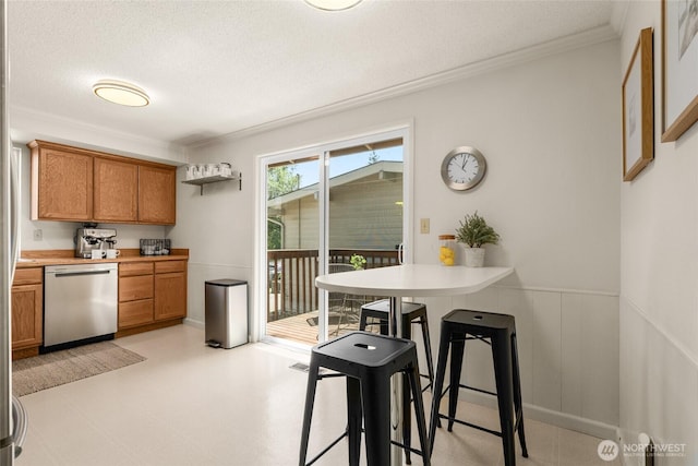2127 170th Ave NE, Bellevue, WA 98008 - kitchen featuring dishwasher, brown cabinetry, crown molding, wainscoting, and light countertops