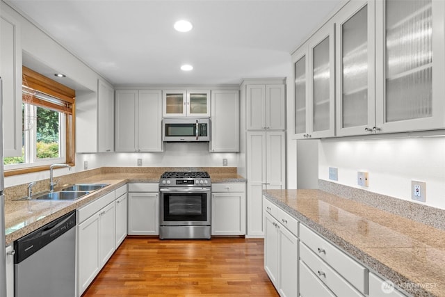1103 Fieldcrest Ave, Centralia, WA 98531 - kitchen featuring stainless steel appliances, light wood-type flooring, tile counters, recessed lighting, and white cabinets