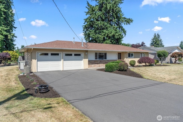 1103 Fieldcrest Ave, Centralia, WA 98531 - ranch-style house featuring an attached garage, driveway, a front yard, and stone siding