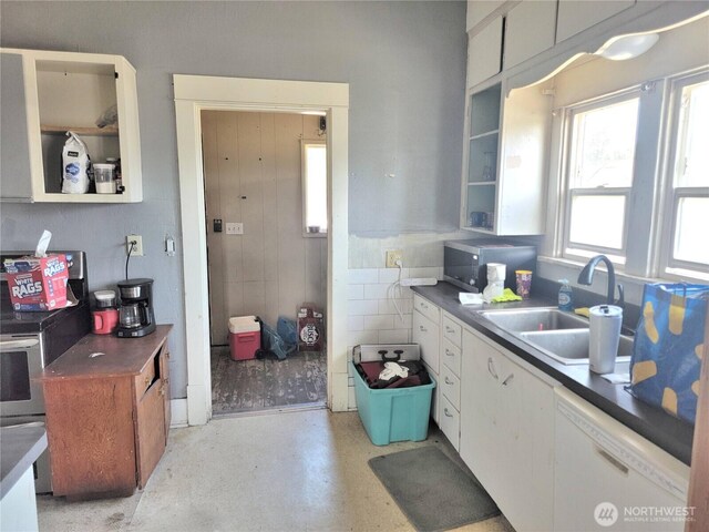 1004 N Tower Ave, Centralia, WA 98531 - kitchen featuring stainless steel microwave, white dishwasher, a sink, and white cabinets