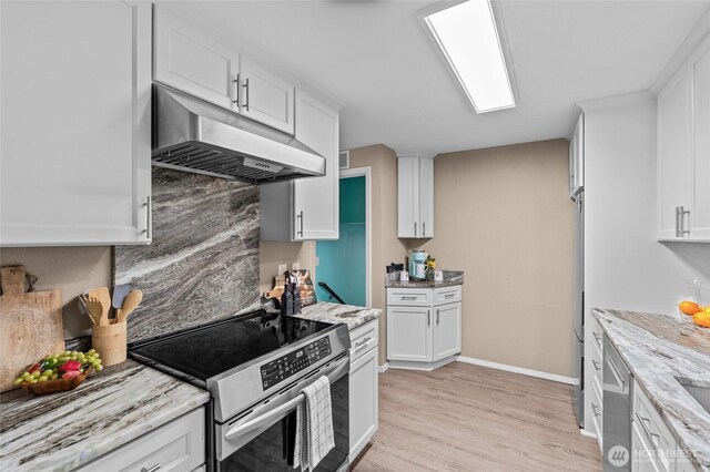 3910 Westpark Ct NW, Olympia, WA 98502 - kitchen with stainless steel appliances, under cabinet range hood, white cabinetry, light wood-style flooring, and light stone counters