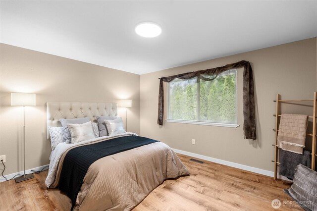 3910 Westpark Ct NW, Olympia, WA 98502 - bedroom featuring baseboards and wood finished floors