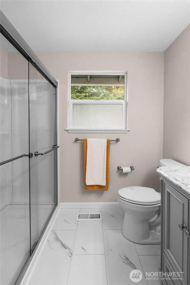 3910 Westpark Ct NW, Olympia, WA 98502 - full bath featuring vanity, a shower stall, and marble look tiles