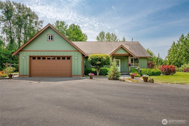9206 Delta Line Rd, Custer, WA 98240 - view of front facade with board and batten siding, driveway, a garage, and roof with shingles