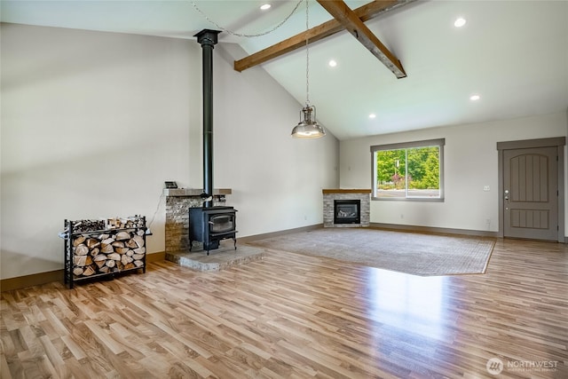 9206 Delta Line Rd, Custer, WA 98240 - unfurnished living room featuring beamed ceiling, wood finished floors, a wood stove, recessed lighting, and high vaulted ceiling