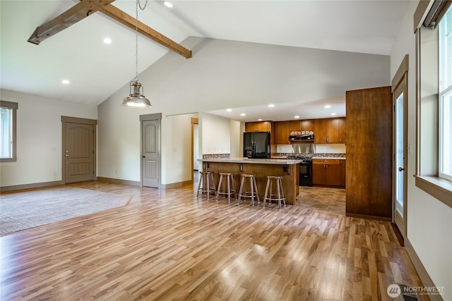 9206 Delta Line Rd, Custer, WA 98240 - kitchen with black refrigerator with ice dispenser, brown cabinets, high vaulted ceiling, gas stove, and a breakfast bar area