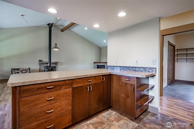 9206 Delta Line Rd, Custer, WA 98240 - kitchen featuring light countertops, a peninsula, open shelves, a wood stove, and brown cabinets