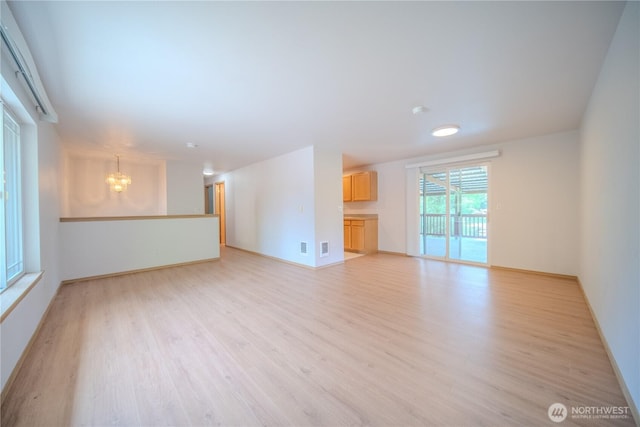 10410 206th Ave E, Bonney Lake, WA 98391 - spare room featuring a chandelier and light wood-style floors