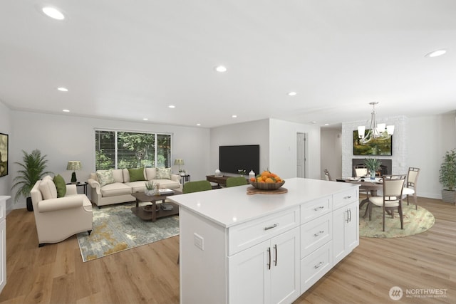 12820 E 129th St, Puyallup, WA 98374 - kitchen featuring a center island, light wood-style floors, open floor plan, white cabinets, and recessed lighting