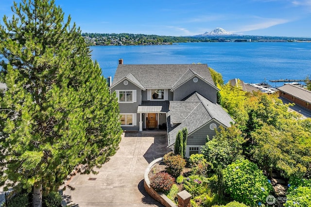 8260 Avalon Dr, Mercer Island, WA 98040 - view of front facade featuring a water view, driveway, a chimney, and roof with shingles