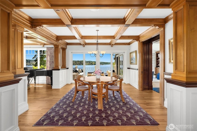 8260 Avalon Dr, Mercer Island, WA 98040 - dining room featuring light wood finished floors, beamed ceiling, a decorative wall, ornate columns, and a chandelier