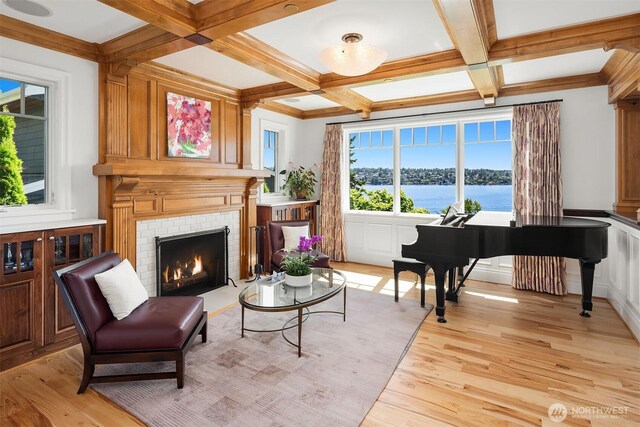 8260 Avalon Dr, Mercer Island, WA 98040 - living area featuring coffered ceiling, light wood finished floors, a brick fireplace, beamed ceiling, and a water view