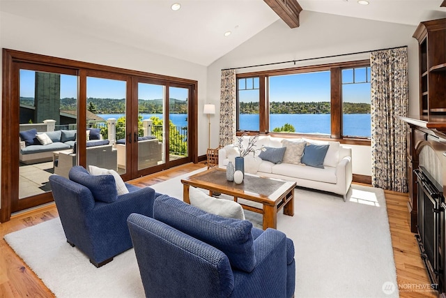 8260 Avalon Dr, Mercer Island, WA 98040 - living room with light wood finished floors, recessed lighting, a water view, and french doors