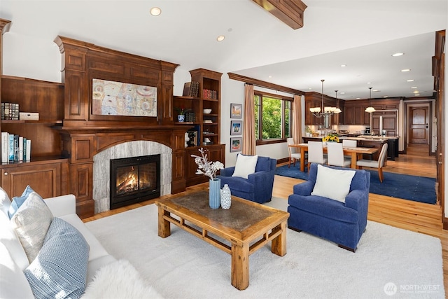 8260 Avalon Dr, Mercer Island, WA 98040 - living area with light wood-type flooring, a fireplace, recessed lighting, and a chandelier