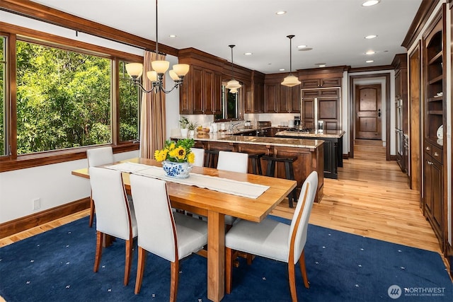8260 Avalon Dr, Mercer Island, WA 98040 - dining area with healthy amount of natural light, light wood-type flooring, a chandelier, recessed lighting, and baseboards
