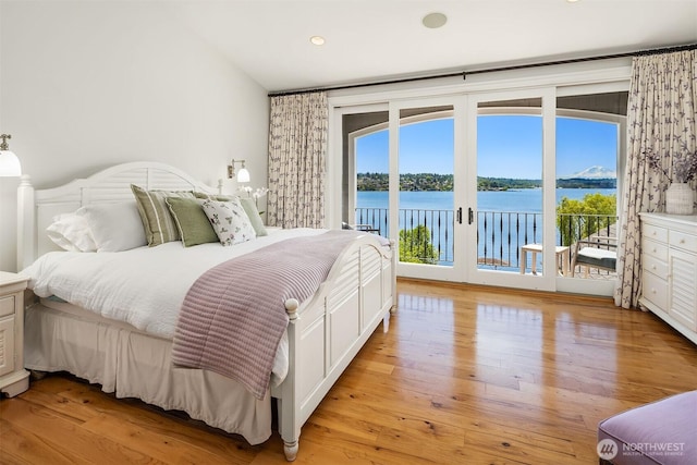 8260 Avalon Dr, Mercer Island, WA 98040 - bedroom with access to exterior, a water view, light wood finished floors, and recessed lighting