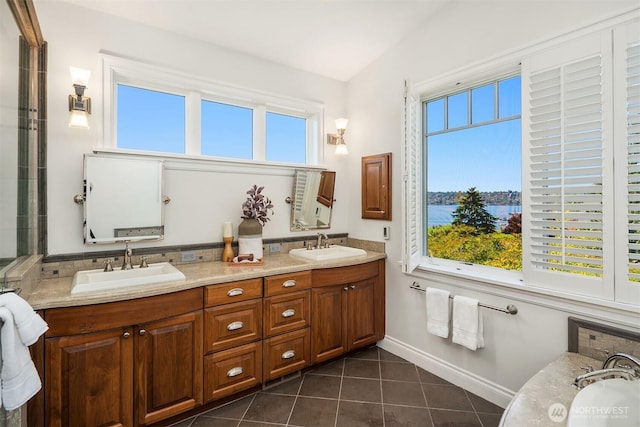 8260 Avalon Dr, Mercer Island, WA 98040 - bathroom with double vanity, healthy amount of natural light, tile patterned flooring, and baseboards
