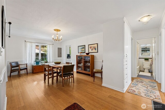 4919 N 31st St, Tacoma, WA 98407 - dining area featuring a chandelier, light wood-style flooring, and electric panel