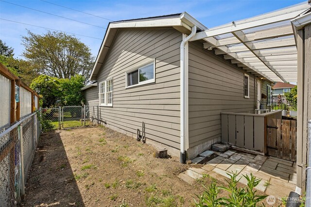 4919 N 31st St, Tacoma, WA 98407 - view of side of home with a gate and a fenced backyard