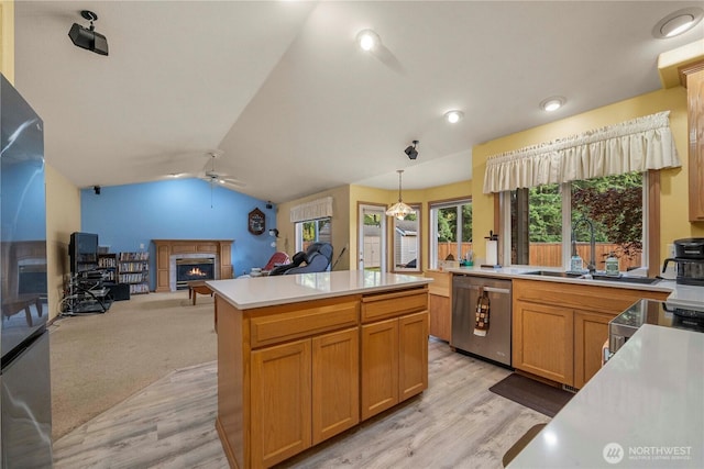 6610 227th Street Ct E, Spanaway, WA 98387 - kitchen with appliances with stainless steel finishes, a warm lit fireplace, a ceiling fan, light countertops, and open floor plan