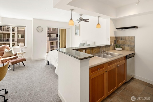1545 NW 57th St Unit 423, Seattle, WA 98107 - kitchen with dishwasher, a sink, decorative light fixtures, a peninsula, and brown cabinetry