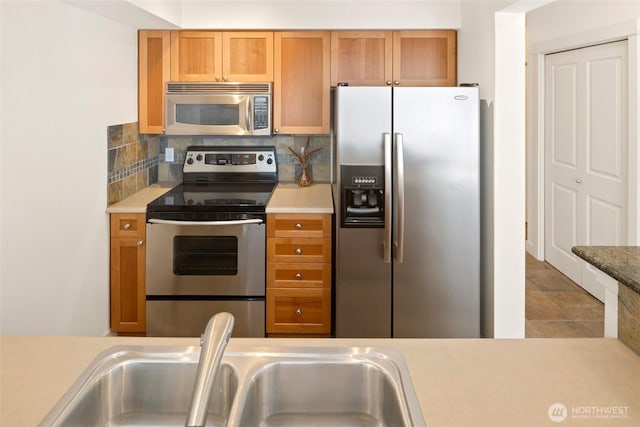 1545 NW 57th St Unit 423, Seattle, WA 98107 - kitchen featuring appliances with stainless steel finishes, light countertops, and tasteful backsplash