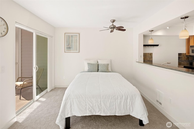 1545 NW 57th St Unit 423, Seattle, WA 98107 - bedroom with carpet, access to exterior, baseboards, and a ceiling fan
