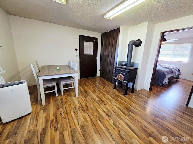 119 N 16th St, Elma, WA 98541 - entryway featuring wood finished floors, a textured ceiling, and a wood stove