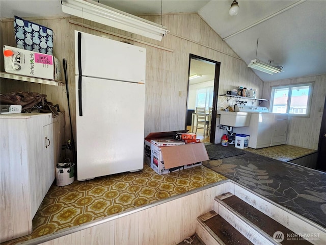 119 N 16th St, Elma, WA 98541 - kitchen featuring freestanding refrigerator, vaulted ceiling, plenty of natural light, and separate washer and dryer