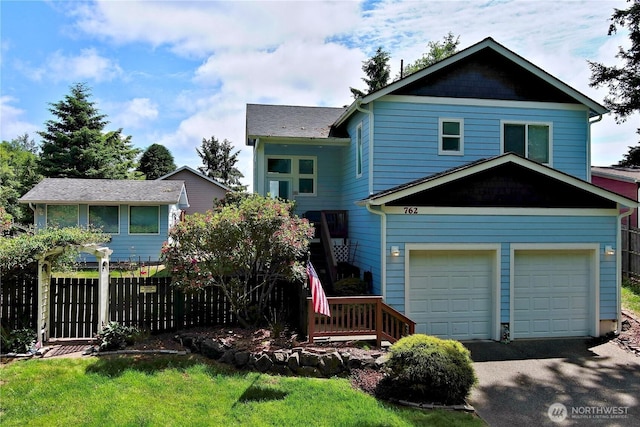 762 Evergreen Ave SE, Ocean Shores, WA 98569 - view of front of home featuring an attached garage and asphalt driveway