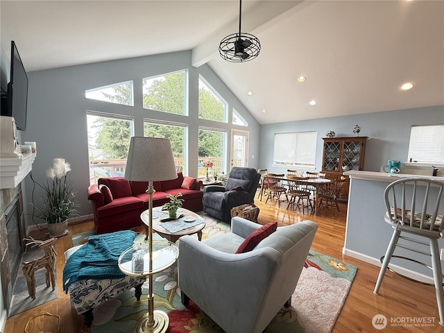 762 Evergreen Ave SE, Ocean Shores, WA 98569 - living area with beamed ceiling, a high end fireplace, light wood finished floors, recessed lighting, and high vaulted ceiling