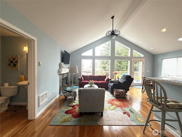 762 Evergreen Ave SE, Ocean Shores, WA 98569 - living room with hardwood / wood-style floors, healthy amount of natural light, a tile fireplace, lofted ceiling, and recessed lighting