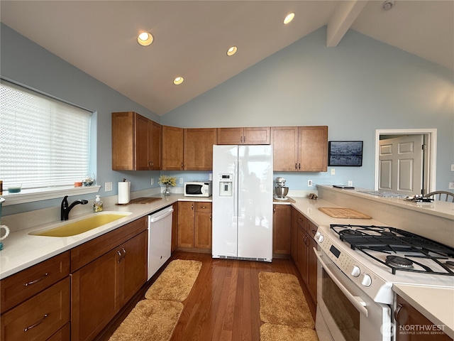 762 Evergreen Ave SE, Ocean Shores, WA 98569 - kitchen with white appliances, high vaulted ceiling, dark wood-style floors, brown cabinets, and light countertops