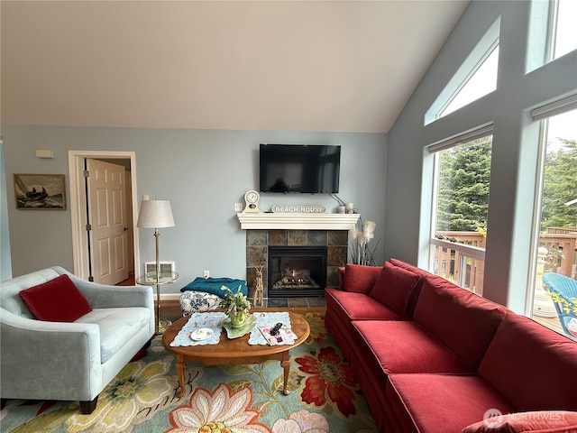 762 Evergreen Ave SE, Ocean Shores, WA 98569 - living area with vaulted ceiling, a tile fireplace, and wood finished floors