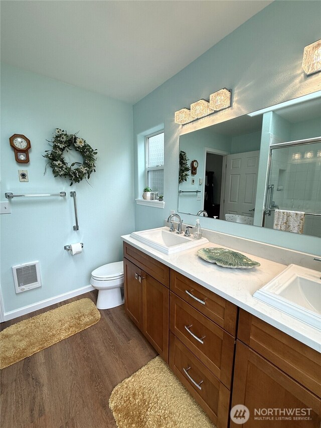 762 Evergreen Ave SE, Ocean Shores, WA 98569 - full bath featuring a shower stall, double vanity, wood finished floors, and heating unit