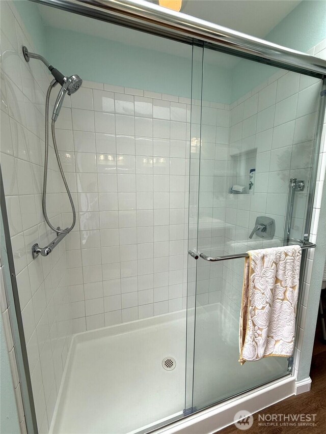 762 Evergreen Ave SE, Ocean Shores, WA 98569 - bathroom with a stall shower and wood finished floors