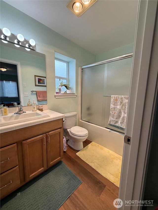 762 Evergreen Ave SE, Ocean Shores, WA 98569 - bathroom featuring vanity, wood finished floors, and combined bath / shower with glass door
