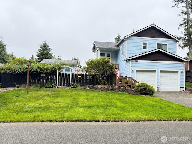 762 Evergreen Ave SE, Ocean Shores, WA 98569 - view of front of house featuring a garage and asphalt driveway