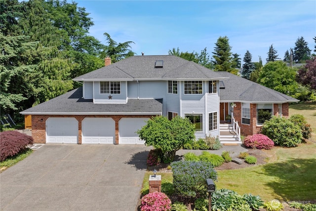 1612 SW 304th St, Federal Way, WA 98023 - view of front of home with brick siding, driveway, a chimney, roof with shingles, and an attached garage