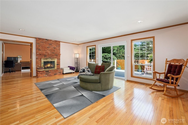 1612 SW 304th St, Federal Way, WA 98023 - living room with light wood finished floors, ornamental molding, a brick fireplace, and recessed lighting