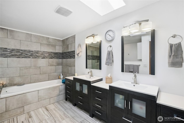 1612 SW 304th St, Federal Way, WA 98023 - full bathroom featuring a skylight, tiled bath, and two vanities