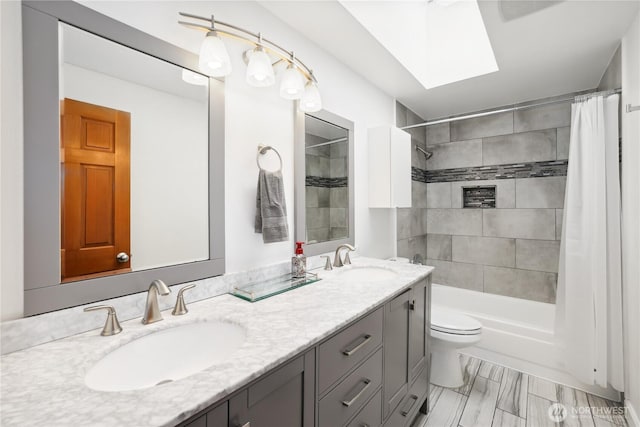 1612 SW 304th St, Federal Way, WA 98023 - full bathroom featuring double vanity, shower / bath combo, and a skylight